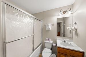 a bathroom with a shower and a toilet and a sink at Heaven Sent by American Patriot Getaways in Henderson Springs +24 photos