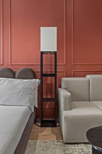 a bedroom with a bed and a chair and a lamp at Cozy Downtown Studio Free Pool Close to DT in Tampa