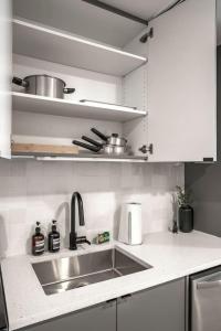 a kitchen with a sink and a counter top at Cozy Downtown Studio Free Pool Close to DT in Tampa +12 photos