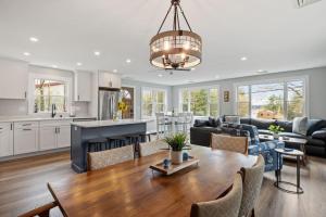 a kitchen and living room with a dining room and a table at Central Location 4BR w Boat Slip Option in Gilford