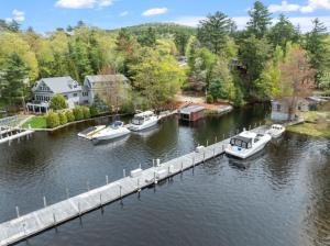 a group of boats docked at a dock on a river at Central Location 4BR w Boat Slip Option in Gilford