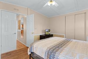 a bedroom with a bed and a ceiling fan at Sunlit 2BR with Lanai on Golf Cart Path in Lady Lake +30 photos