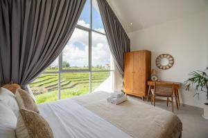 a bedroom with a bed and a large window at Sunrise Bliss 13 Ricefield View Private Pool Villa By Bali Bliss Properties in Dalung +62 photos