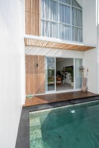 a house with a swimming pool in front of a house at Sunrise Bliss 13 Ricefield View Private Pool Villa By Bali Bliss Properties in Dalung