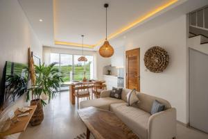 a living room with a couch and a table at Sunrise Bliss 13 Ricefield View Private Pool Villa By Bali Bliss Properties in Dalung