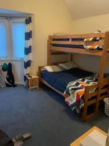 a bedroom with two bunk beds and a window at 3BR Lake Winnipesaukee Condo with Sandy Beach in Laconia
