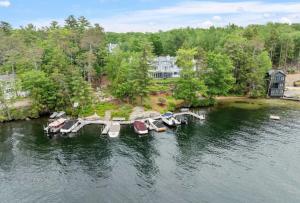 an aerial view of a dock with boats in the water at 3BR Lake Winnipesaukee Condo with Sandy Beach in Laconia