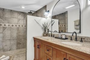 a bathroom with two sinks and a shower at Spacious Luxe Condo in Historic Downtown Wolfeboro in Wolfeboro +101 photos
