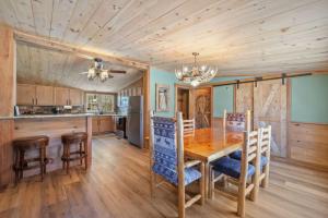 a kitchen and dining room with a wooden table and chairs at Cozy 3BR with Firepit and Boat Slip Option in Moultonborough