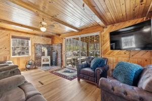 a living room with couches and a television and a fireplace at Cozy 3BR with Firepit and Boat Slip Option in Moultonborough