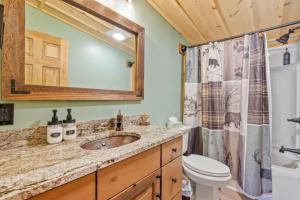 a bathroom with a sink and a toilet and a shower at Cozy 3BR with Firepit and Boat Slip Option in Moultonborough +53 photos