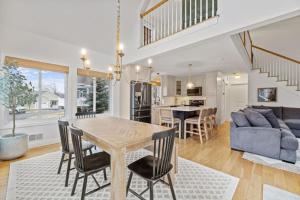 a dining room and living room with a table and chairs at 3BR plus Loft with Pool, Firepit, Walk to Boardwalk in Laconia