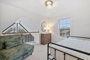 a bedroom with a bed and a chair and a window at 3BR plus Loft with Pool, Firepit, Walk to Boardwalk in Laconia +50 photos