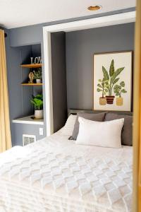 a bedroom with a white bed and a blue wall at Walk to Concerts Beach with Pool View in Gilford