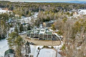 an aerial view of a large house in the snow at Walk to Concerts Beach with Pool View in Gilford