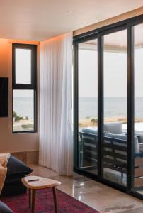 a living room with a view of the ocean at Distrito Puerto, Ocean & Mangrove Views in Puerto Morelos