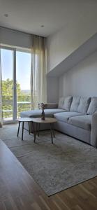 a living room with a couch and a coffee table at Runo Apartamenty - komfort i widok w centrum miasta in Sanok