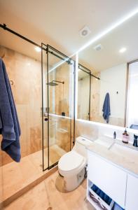 a bathroom with a toilet and a shower at Distrito Puerto, Ocean & Mangrove Views in Puerto Morelos +28 photos