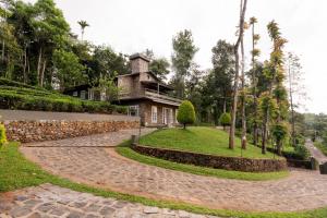 a house with a stone path leading to a building at Semni Escape Plantation Bungalow-Vagamon in Vagamon