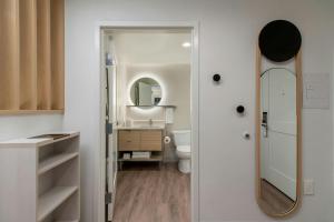 a bathroom with a sink and a mirror at TownePlace Suites by Marriott Forrest City in Forrest City