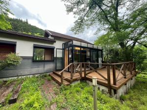 a modern house with a large wooden deck at Okutama Guesthouse - Vacation STAY 45619v in Hikawa