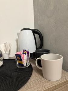 a coffee pot and a cup on a table at La finestra sul Farfa in Bocchignano