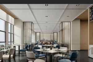 a dining room with tables and chairs and windows at Fairfield Inn by Marriott Xinzhou Xinfu in Xinzhou