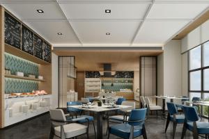 a rendering of a restaurant with tables and chairs at Fairfield Inn by Marriott Xinzhou Xinfu in Xinzhou