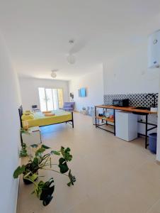 a living room with a yellow bed and a table at Gozo Vacation Studios in Nadur