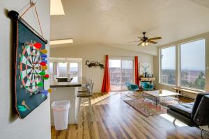 a living room with a dart board on the wall at Moab House Near Arches Natl Park and Canyonlands! in Moab