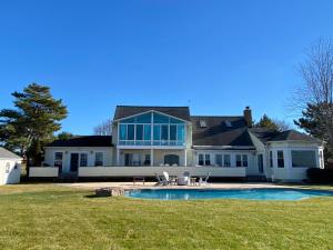 a large house with a swimming pool in the yard at Bay Breeze in Grasonville