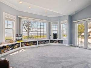 a large room with windows and bookshelves at Bay Breeze in Grasonville +62 photos