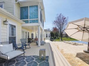 a porch with chairs and an umbrella on a house at Bay Breeze in Grasonville