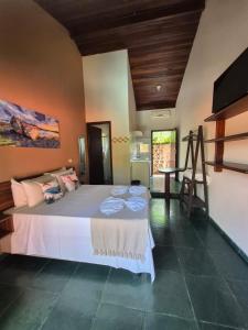 a bedroom with a large white bed in a room at Mambuca Village in Ubatuba +84 photos