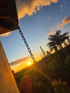 a hammock with the sunset in the background at Chácara Duquinha 3 in Triunfo