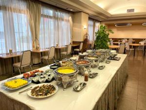 a buffet line of food on a long table at Smile Hotel Yonago - Vacation STAY 97661v in Yonago +17 photos