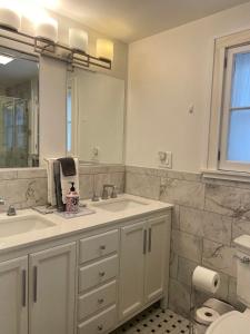 a bathroom with a sink and a mirror at The Lookout - Spacious Apartment in Superb Location in Burlington