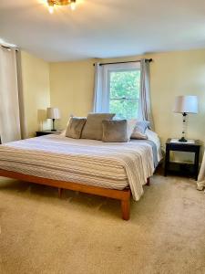 a large bed in a bedroom with a window at The Lookout - Spacious Apartment in Superb Location in Burlington