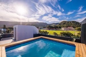 a swimming pool on the roof of a house at Chic Coastal Hideaway in Hermanus
