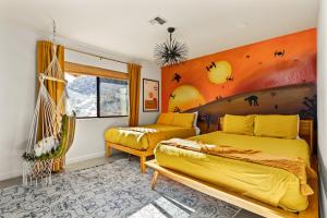 a bedroom with a yellow bed and a window at Good Luck Outpost By The Cohost Company in Yucca Valley +55 photos