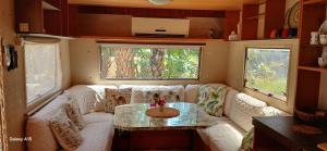 a living room with a white couch and a glass table at Coco Oasis Resort Camping Maison d hotes in Tozeur