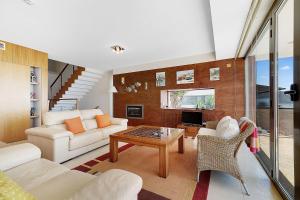 a living room with a couch and a table at Som do Mar Luxury Ocean Front Villa, Prime Location! in Luz