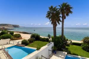a view of the ocean from the balcony of a house at Som do Mar Luxury Ocean Front Villa, Prime Location! in Luz