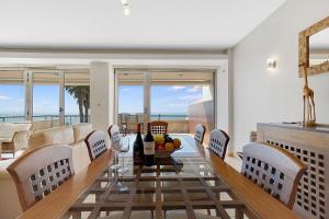a dining room with a table and chairs at Som do Mar Luxury Ocean Front Villa, Prime Location! in Luz