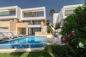an image of a house with a swimming pool at Som do Mar Luxury Ocean Front Villa, Prime Location! in Luz