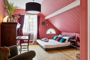 a bedroom with a red wall with a bed in it at Private mansion for family, friends or colleagues 