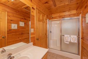 a bathroom with a shower and a sink at HIckernut Lodge by American Patriot Getaways in Walnut Grove +31 photos