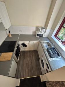 a small kitchen with a washing machine and a sink at Tranquil 1BR in Edmonton in Edmonton