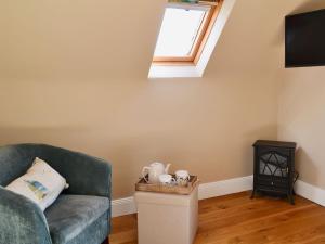 a living room with a couch and a window at Rock Cottage in Saint Abbs
