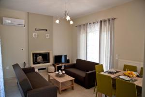 a living room with a couch and a table at Eco Villas Diakopto in Diakopto